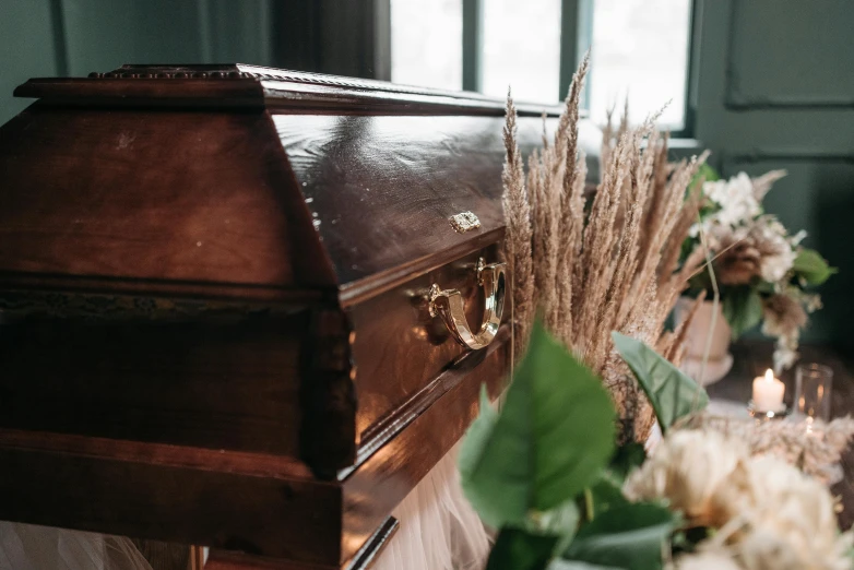 a wooden casket sitting on top of a table, trending on pexels, vanitas, dead plants and flowers, fan favorite, frank moth, shroud