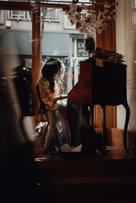 a woman sitting at a desk in front of a window, an album cover, pexels contest winner, baroque, real pianos, inside an old magical shop, brandon woelfel, profile image