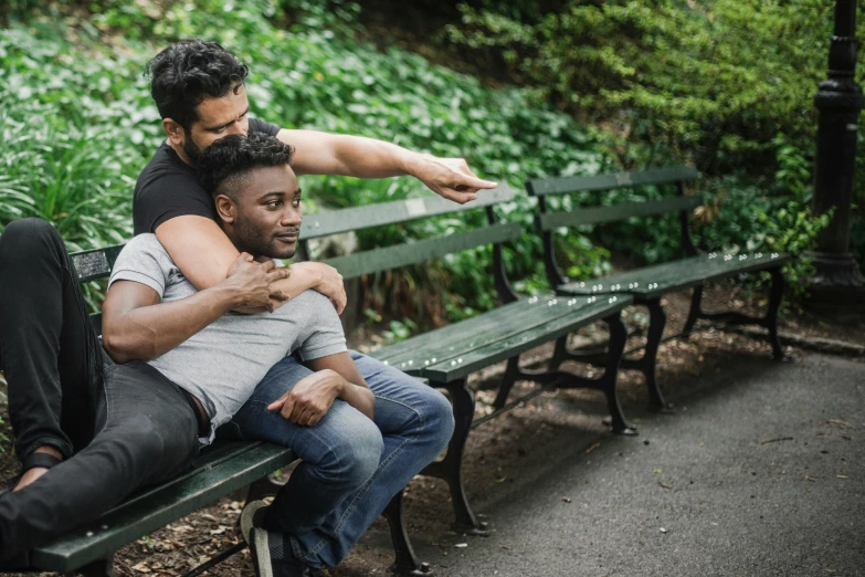 a couple of men sitting on top of a green bench, pexels contest winner, renaissance, holding each other, riyahd cassiem, lgbt, at a park