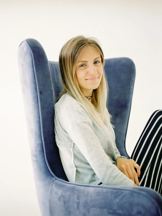 a woman is sitting in a blue chair, discord profile picture, jovana rikalo, grey, sofya emelenko