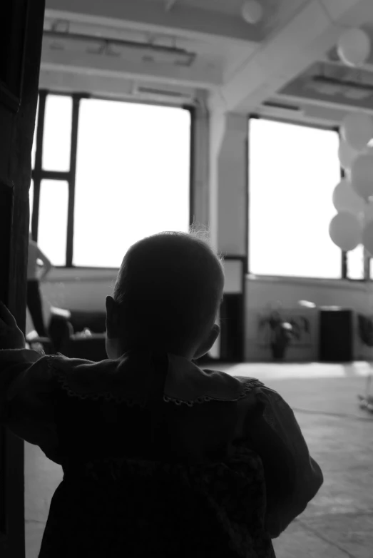 a little girl that is standing in front of a door, a black and white photo, fluxus, baloons, man sitting facing away, 15081959 21121991 01012000 4k, concert