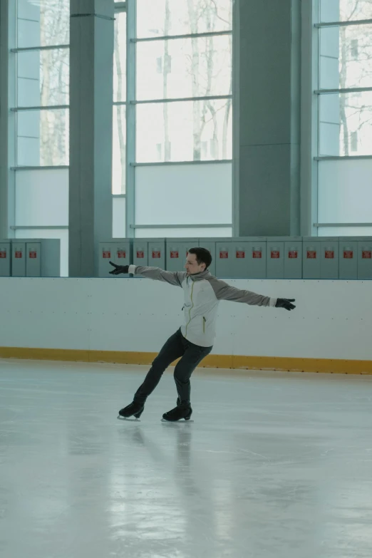 a man riding a skateboard on top of an ice rink, inspired by Fei Danxu, arabesque, **cinematic, andrea savchenko, still frame, christopher cao