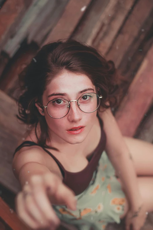 a woman sitting on top of a wooden bench, a picture, inspired by Elsa Bleda, trending on pexels, renaissance, square rimmed glasses, selfie photo, girl cute-fine-face, 2 4 mm iso 8 0 0 color