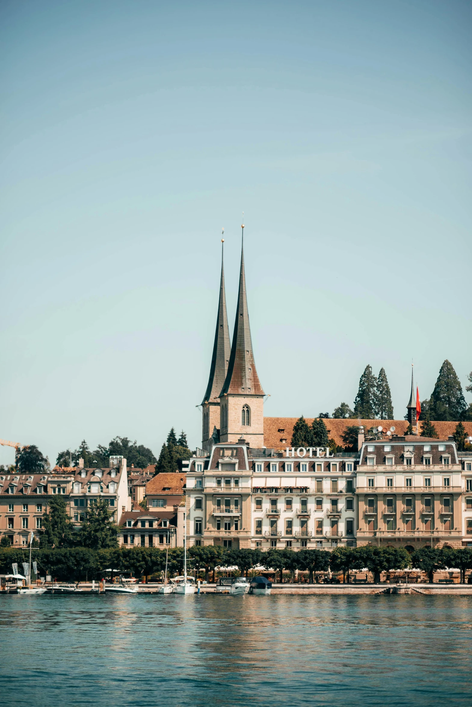 a large body of water with buildings in the background, by Karl Stauffer-Bern, pexels contest winner, asymmetrical spires, 2 5 6 x 2 5 6, high quality photo, high resolution photo