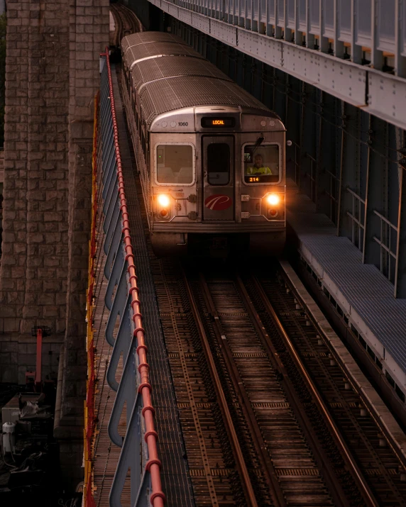 a large long train on a steel track, by Matt Stewart, unsplash contest winner, mta subway entrance, lgbtq, hell gate, early evening