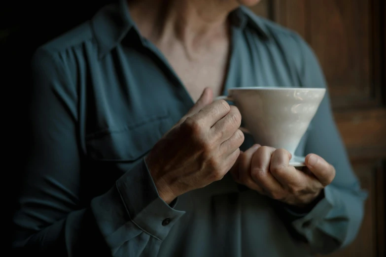 a close up of a person holding a cup, by Eglon van der Neer, trending on unsplash, renaissance, lightly dressed, late - 4 0 s aged, intimate holding close, anthro