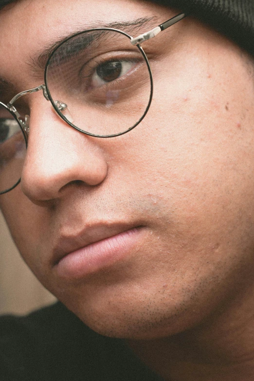 a close up of a person wearing glasses and a hat, reddit, medium skin tone, cleanshaven!, concerned, high school