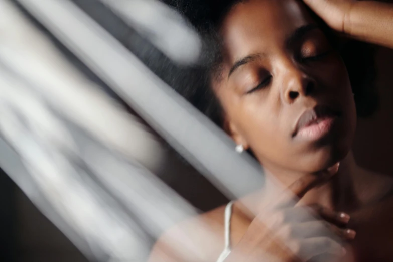 a close up of a woman with her eyes closed, inspired by Gordon Parks, pexels contest winner, in the bedroom at a sleepover, maria borges, thumbnail, translucent