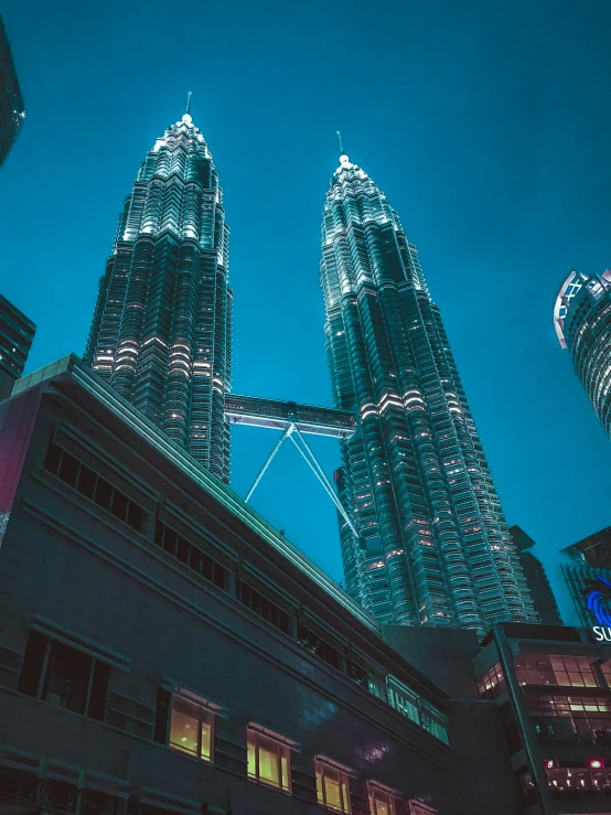 the petrona towers are lit up at night, pexels contest winner, hurufiyya, blue toned, cinematic”