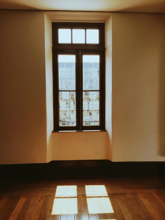 a room with a window and a hard wood floor, a picture, inspired by Elsa Bleda, unsplash contest winner, light and space, taken on iphone 14 pro, window ( city ), church window, side light