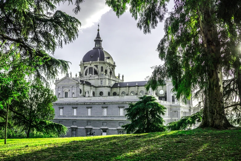 a large building sitting on top of a lush green field, inspired by Christopher Wren, pexels contest winner, baroque, madrid, parce sepulto, grey, panoramic