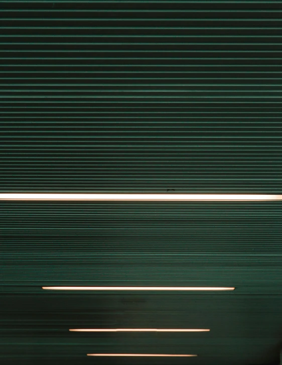 a red stop sign sitting on the side of a road, an album cover, inspired by Andreas Gursky, unsplash, postminimalism, ( ( dark green, soft light through blinds, alessio albi, abstract detail