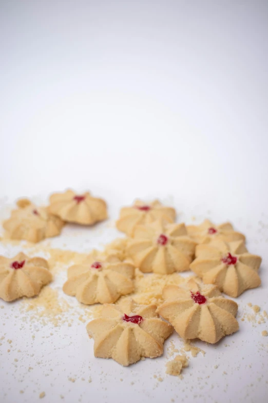 a bunch of cookies sitting on top of a table, tiny crimson petals falling, red!! sand, high quality product image”, hasselblatt