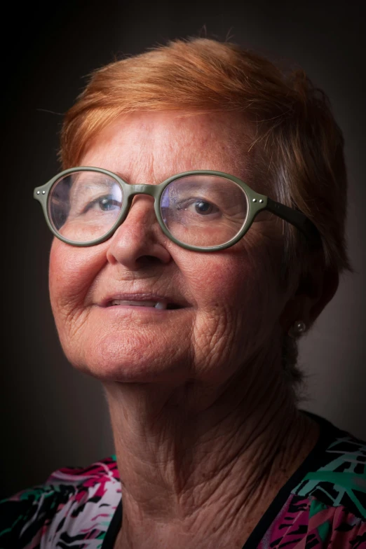 a close up of a person wearing glasses, by Betty Churcher, studio photographic portrait, elderly, woman with red hair, digital image