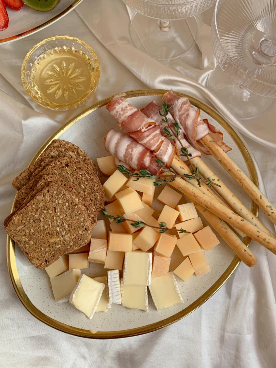 a close up of a plate of food on a table, cheese and salami on the table, profile image