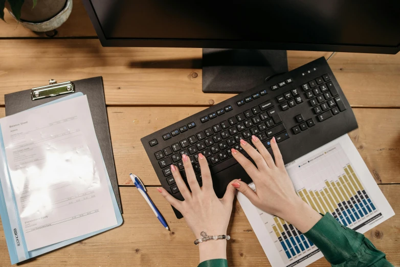 a woman is typing on a computer keyboard, trending on pexels, analytical art, background image, high angle shot, wooden desks with books, avatar image