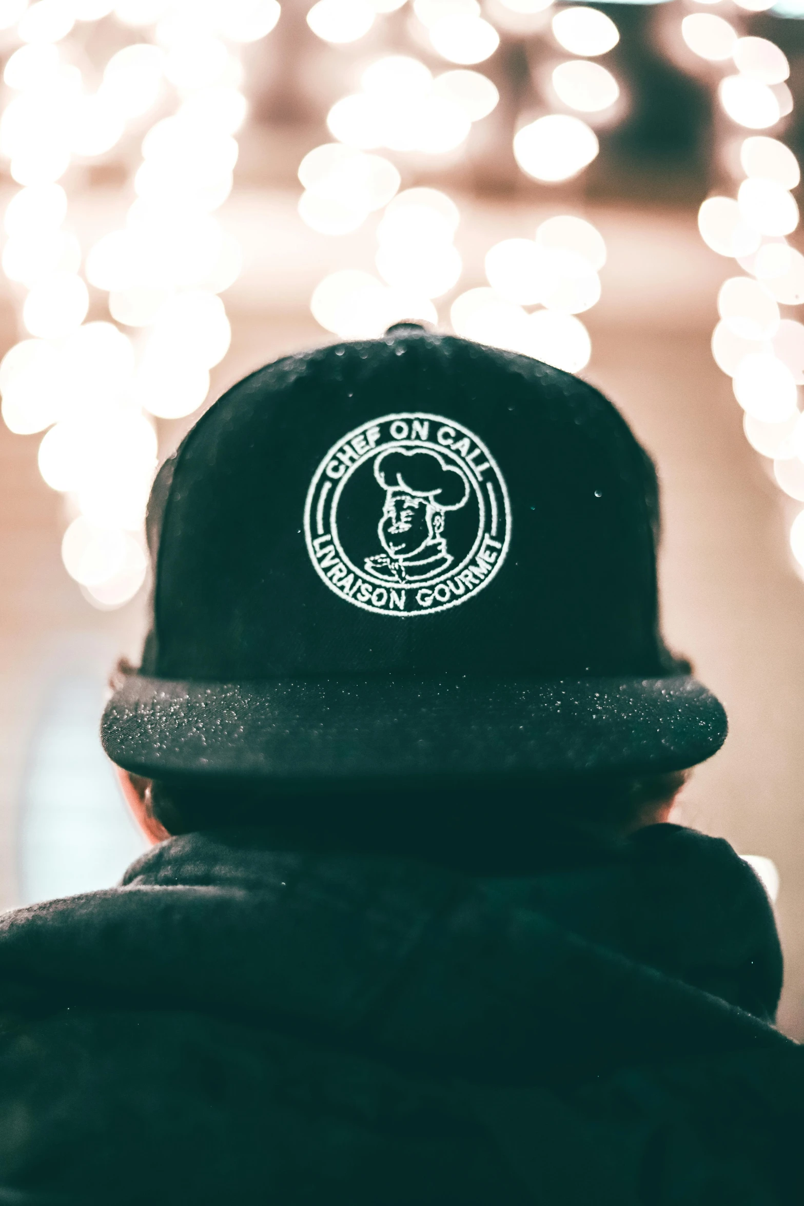 a close up of a person wearing a hat, a cartoon, by Tom Bonson, unsplash contest winner, embroidered velvet, black and white logo, ready to eat, long night cap