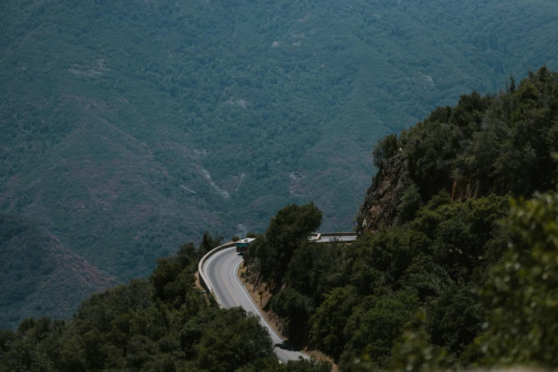 a car driving down a winding mountain road, unsplash contest winner, les nabis, 2 5 6 x 2 5 6 pixels, central california, 🚿🗝📝, view from the side