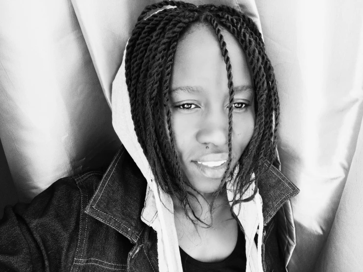a black and white photo of a woman with dreadlocks, a black and white photo, hurufiyya, facebook profile picture, emmanuel shiru, black teenage boy, androgynous person