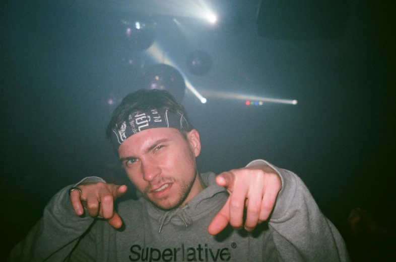 a close up of a person pointing at something, a hologram, superflat, 90’s photography, marshal mathers, portrait image, fujicolor with flash