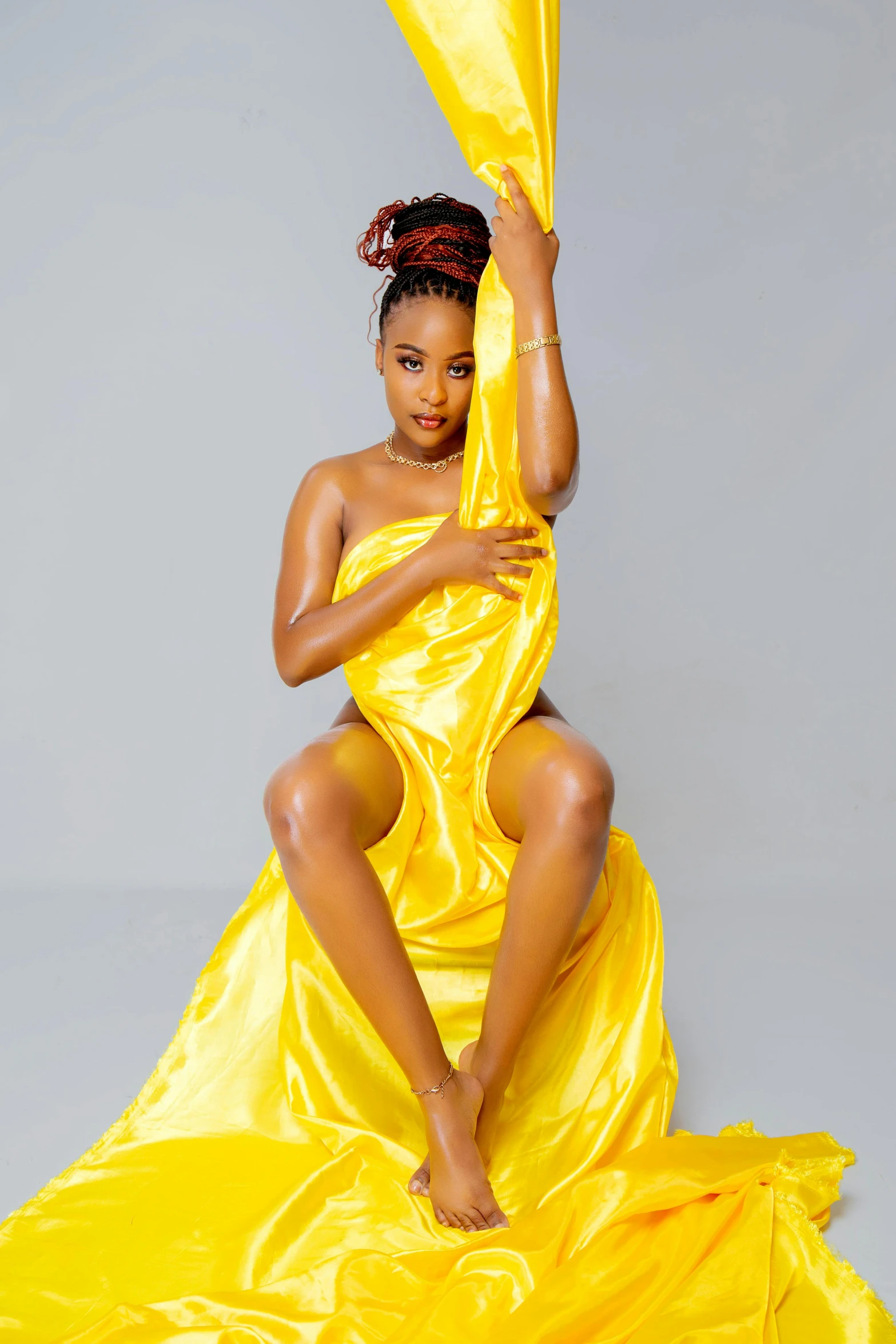 a woman in a yellow dress sitting on a yellow sheet, an album cover, by Chinwe Chukwuogo-Roy, trending on pexels, sexy pudica pose gesture, 15081959 21121991 01012000 4k, flowing neon-colored silk, 'white background'!!!