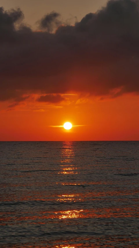 the sun is setting on the horizon of the ocean, by Jan Tengnagel, pexels contest winner, romanticism, red sun over paradise, high quality photo, today\'s featured photograph 4k, brown