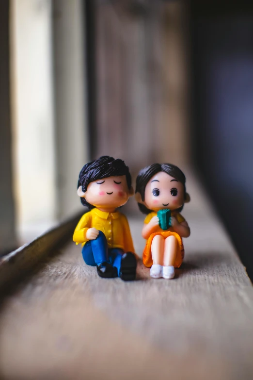 a couple of figurines sitting on top of a window sill, pexels contest winner, asian girl, cute toy, instagram post, plasticine