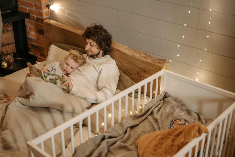 a man and a little girl laying in a crib, pexels contest winner, hygge, profile image, 1 5 0 4, man