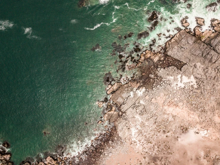 a large body of water next to a beach, pexels contest winner, birdseye view, dark brown white green colours, deeply hyperdetailed, south african coast