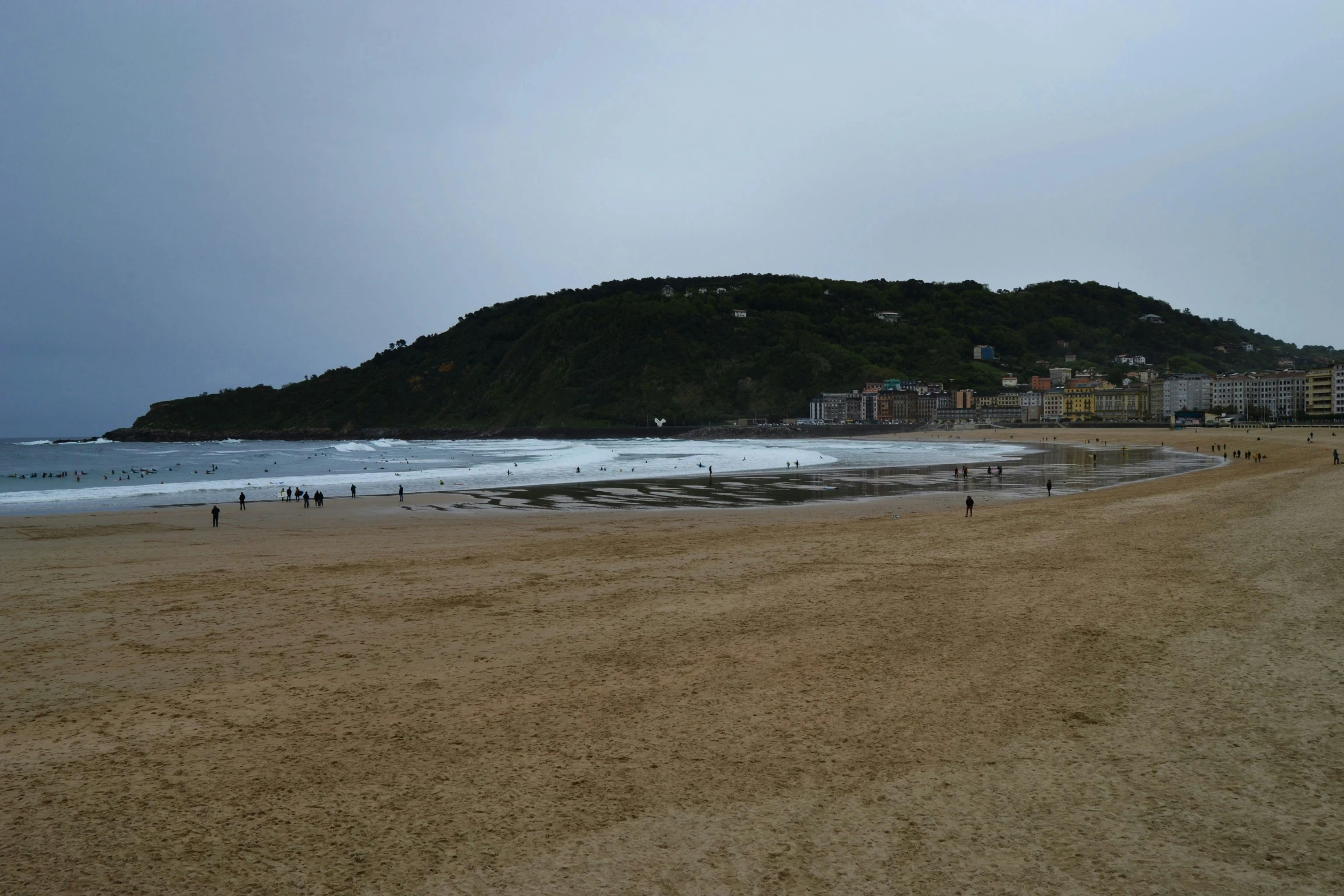 a group of people standing on top of a sandy beach, rosalia vila i tobella, overcast skies, square, information