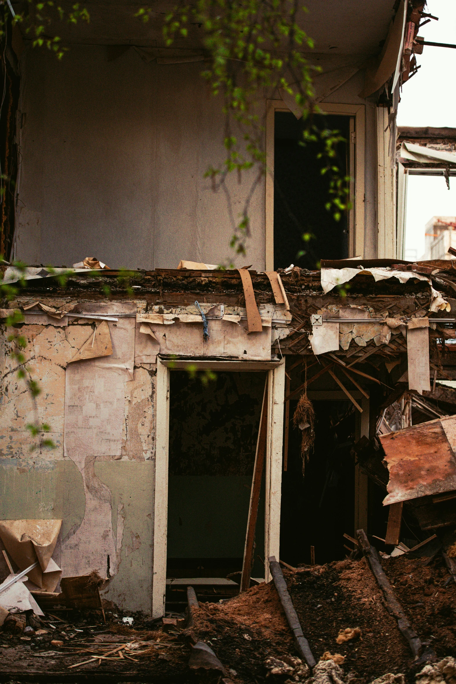 a pile of rubble sitting in front of a building, an album cover, unsplash, abandoned house interior, 1980s photo, overgrown city, nika maisuradze