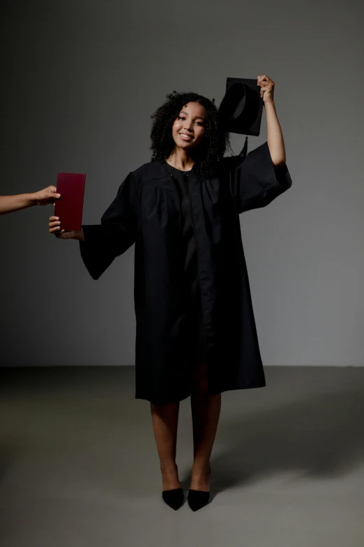 a woman in a graduation gown holding a diploma, by James Morris, ashteroth, dwell, terrifying :7, black