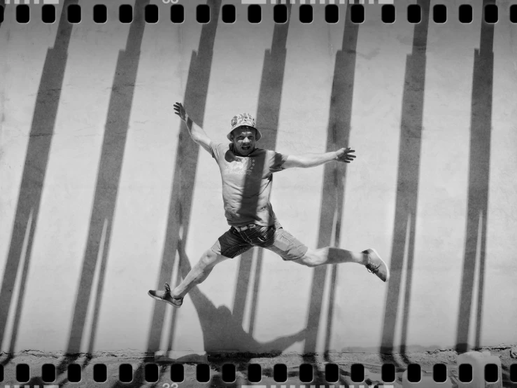 a black and white photo of a man jumping in the air, a black and white photo, inspired by Alexander Rodchenko, photo taken on an old box camera, having fun in the sun, tim burton supersampled, ffffound