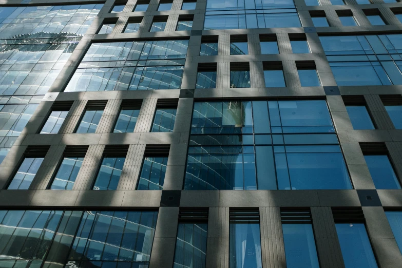 a very tall building with a lot of windows, inspired by János Nagy Balogh, flickr, square lines, stone facade, exterior photo, ground - level view