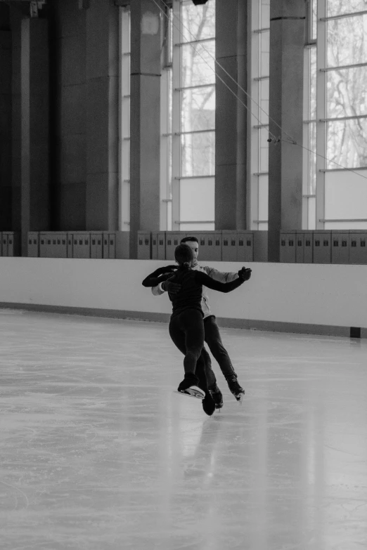 a black and white photo of a man on a skateboard, inspired by Fei Danxu, arabesque, walking on ice, in a large hall, cold as ice! 🧊, dancing elegantly over you