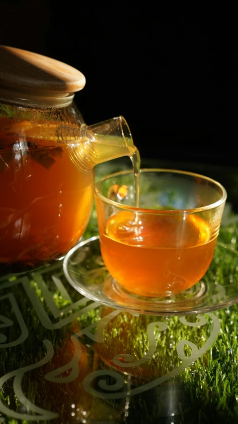 a cup of tea and a teapot on a table, pexels, hurufiyya, orange and green power, square, malaysian, summer night