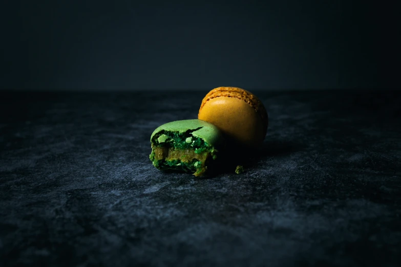 a close up of a piece of food on a table, inspired by Elsa Bleda, unsplash contest winner, visual art, macaron, dark green, taken with canon 5d mk4, made of food