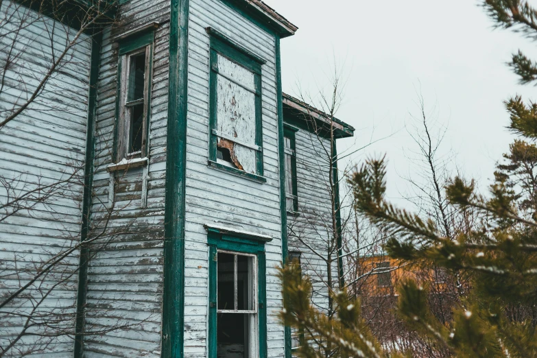 a white and green house with snow on the ground, inspired by Elsa Bleda, pexels contest winner, faded chipped paint, profile image, decayed, two stories