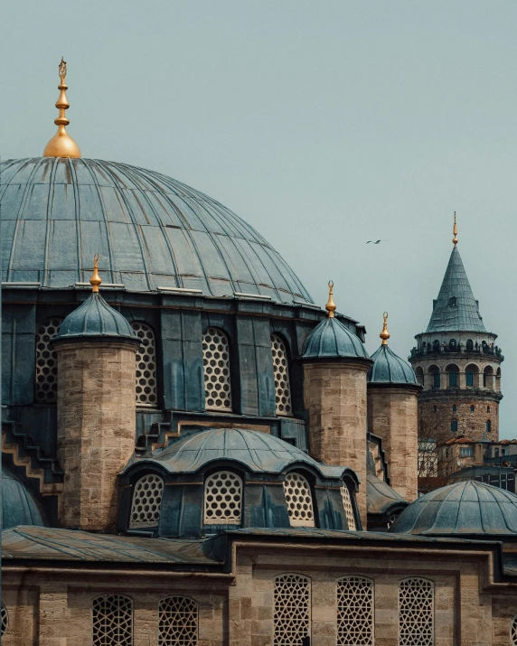 a large building with many domes on top of it, inspired by Osman Hamdi Bey, pexels contest winner, grey, byzantine, turqouise, building in the distance