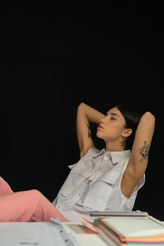 a woman sitting at a desk with her arms behind her head, a tattoo, trending on pexels, hyperrealism, delicate androgynous prince, charli bowater and artgeem, laying down with wrists together, full body image