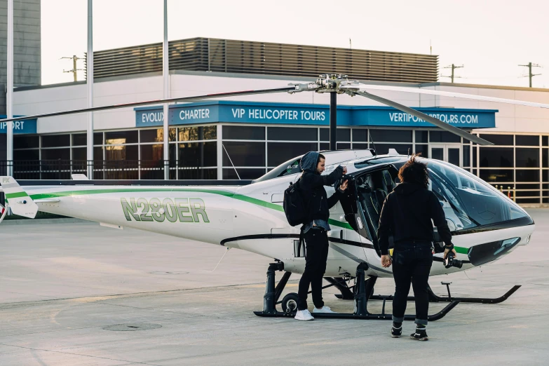 a couple of people standing in front of a helicopter, “zendaya, explore, black. airports, victoria siemer