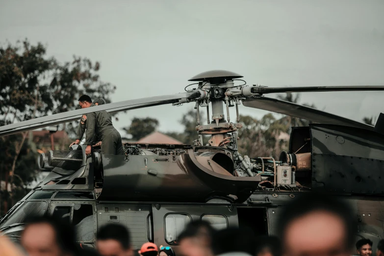 a group of people standing in front of a helicopter, by Adam Marczyński, pexels contest winner, photorealism, realistic military equipment, tiny details, concert, avatar image