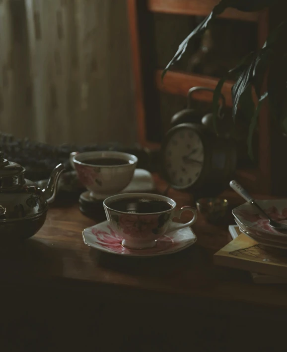 a wooden table topped with cups and saucers, a still life, by Elsa Bleda, unsplash, retro dark vintage, promo image, old timey, in a dark dusty parlor