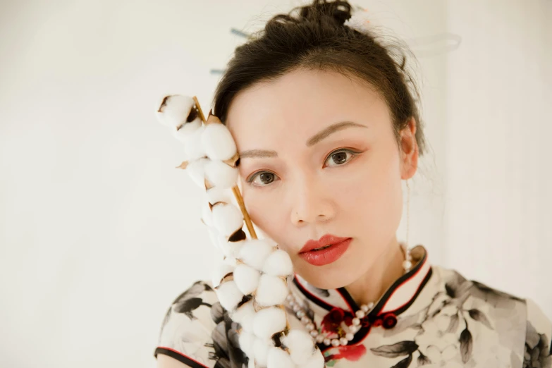 a woman with a bunch of cotton on her head, an album cover, inspired by Xie Huan, trending on pexels, red lips, with acient chinese clothes, shot with sigma f/ 4.2, white porcelain skin