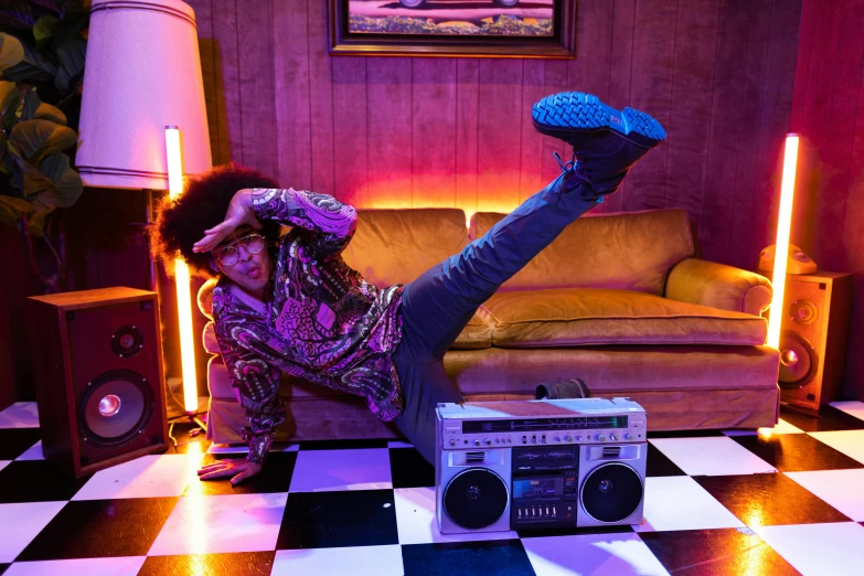 a man laying on a checkered floor next to a boombox, funk art, purple scene lighting, doing a sassy pose, inherent vice, doing a kick