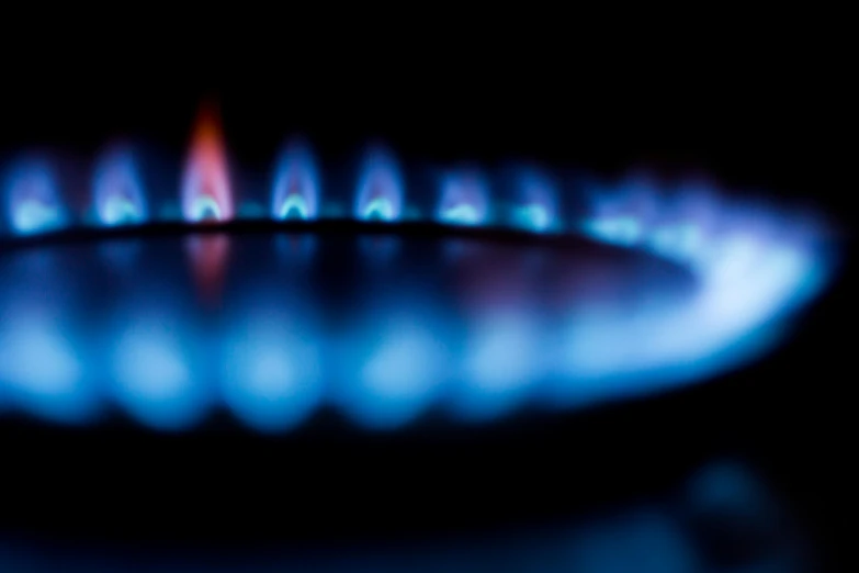 a close up of a gas stove with blue flames, by Matt Cavotta, shutterstock, blurred, thermography, ilustration, petrol energy