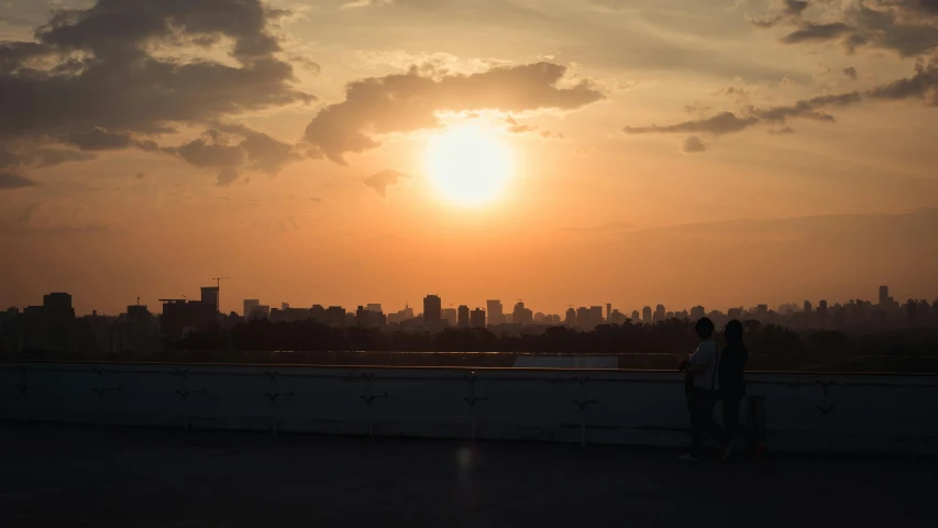 a couple of people standing on top of a roof, pexels contest winner, sunset kanagawa prefecture, beijing, distant photo, fan favorite