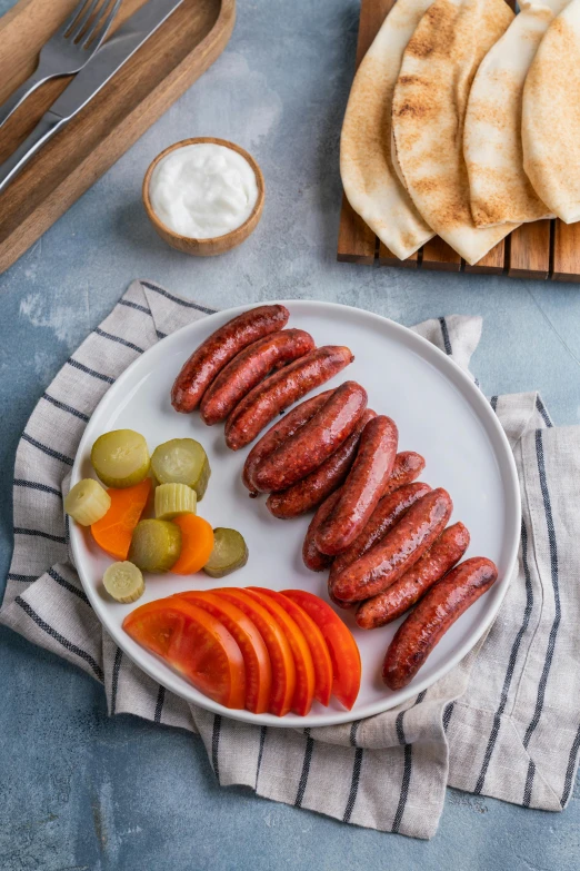 a close up of a plate of food on a table, inspired by Jan Kupecký, dau-al-set, sausages, 6 pack, greek, grey