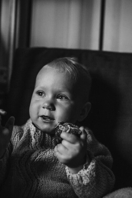 a black and white photo of a baby in a chair, a black and white photo, unsplash, realism, eating cakes, medium format. soft light, ((portrait)), caught in 4 k
