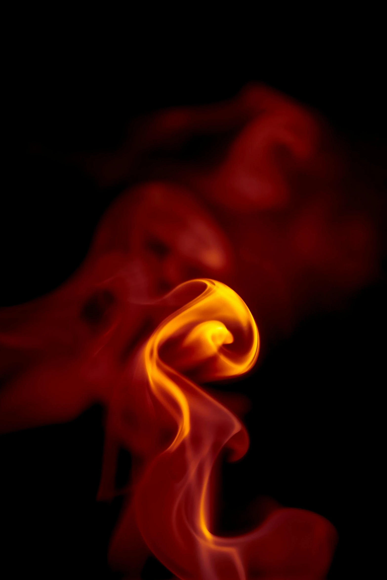a close up of smoke on a black background, a picture, by Greg Rutkowski, red and yellow light, swoosh, small fire, in profile